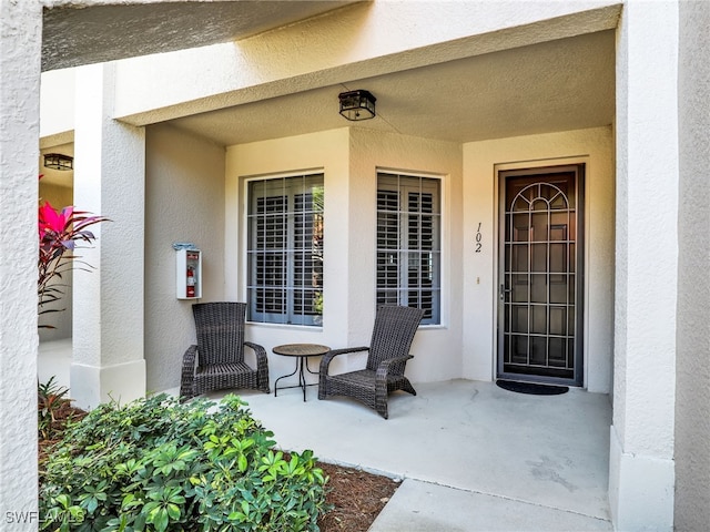 28436 Altessa Way Unit 102, Bonita Springs, FL 34135 - view of exterior entry featuring stucco siding