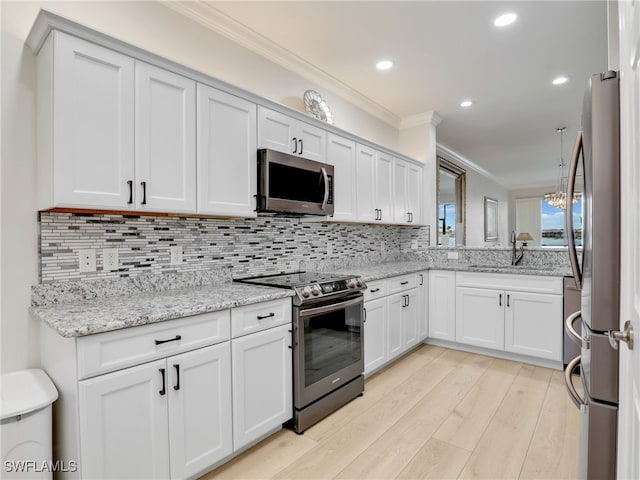 28436 Altessa Way Unit 102, Bonita Springs, FL 34135 - kitchen with ornamental molding, white cabinetry, tasteful backsplash, light wood finished floors, and stainless steel appliances