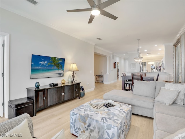 28436 Altessa Way Unit 102, Bonita Springs, FL 34135 - living room featuring visible vents, crown molding, baseboards, ceiling fan with notable chandelier, and light wood-style flooring
