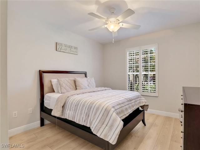 28436 Altessa Way Unit 102, Bonita Springs, FL 34135 - bedroom with baseboards, a ceiling fan, and light wood finished floors