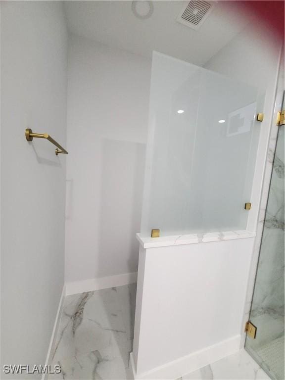 2012 Venice Ave N, Lehigh Acres, FL 33971 - bathroom with a marble finish shower, marble finish floor, visible vents, and baseboards