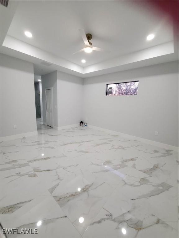 2012 Venice Ave N, Lehigh Acres, FL 33971 - unfurnished room with ceiling fan, recessed lighting, a tray ceiling, and baseboards