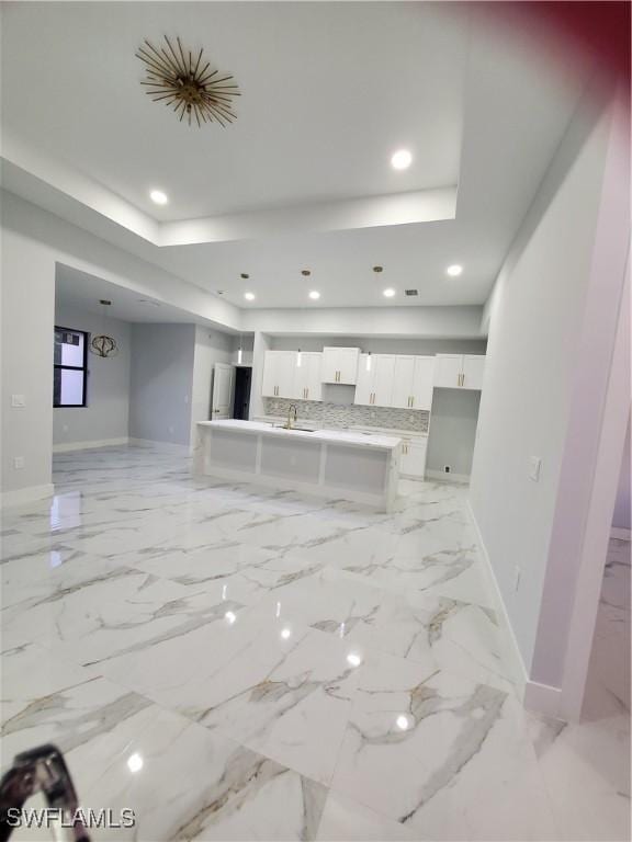 2012 Venice Ave N, Lehigh Acres, FL 33971 - living room featuring baseboards, recessed lighting, marble finish floor, and a tray ceiling