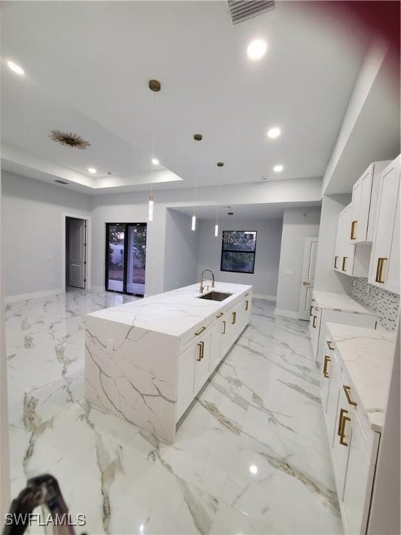 2012 Venice Ave N, Lehigh Acres, FL 33971 - kitchen featuring light stone counters, a sink, visible vents, a large island, and recessed lighting