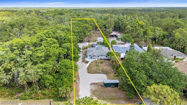 birds eye view of property with a forest view
