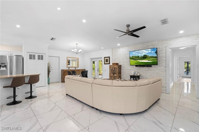 living area featuring visible vents, plenty of natural light, and marble finish floor