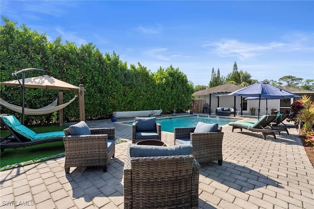 pool with a patio and an outdoor living space