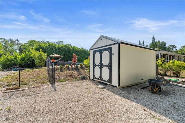 view of shed featuring fence