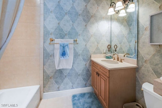 bathroom featuring toilet, vanity, a bathing tub, and tile walls