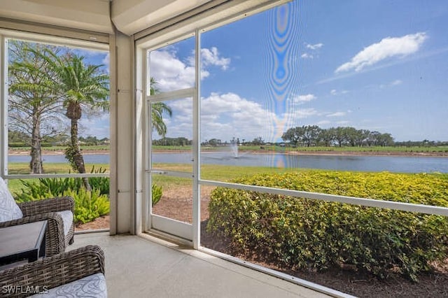 sunroom / solarium with a water view