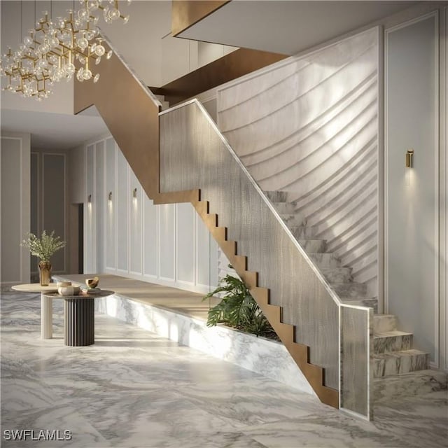 stairway featuring an inviting chandelier