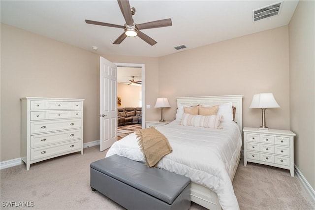 bedroom with baseboards, visible vents, light carpet, and ceiling fan