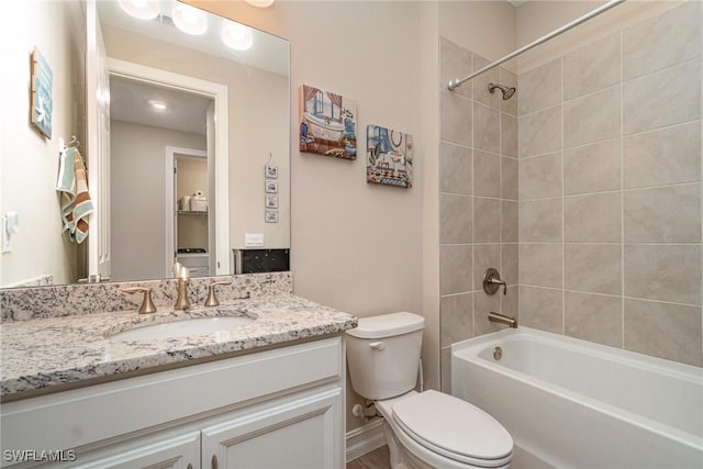 full bath featuring washtub / shower combination, vanity, and toilet