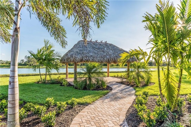 view of property's community with a lawn, a gazebo, and a water view
