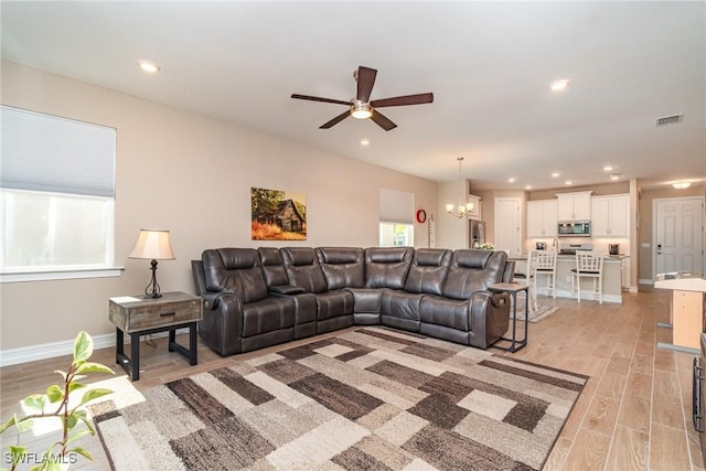 living area featuring light wood finished floors, recessed lighting, baseboards, and ceiling fan with notable chandelier