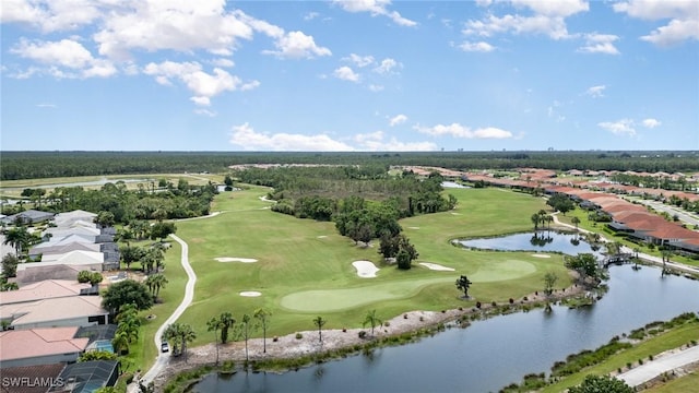 drone / aerial view featuring a residential view, golf course view, and a water view