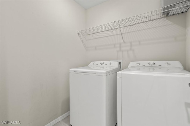 12109 Palm Cove St, Fort Myers, FL 33913 - laundry area with washer and dryer, baseboards, and laundry area