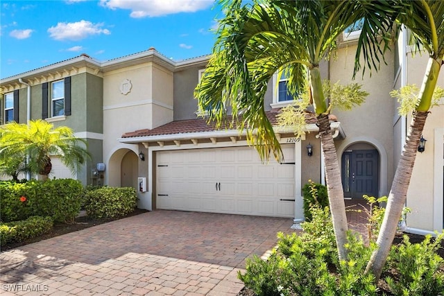 12109 Palm Cove St, Fort Myers, FL 33913 - mediterranean / spanish-style home featuring a garage, decorative driveway, and stucco siding