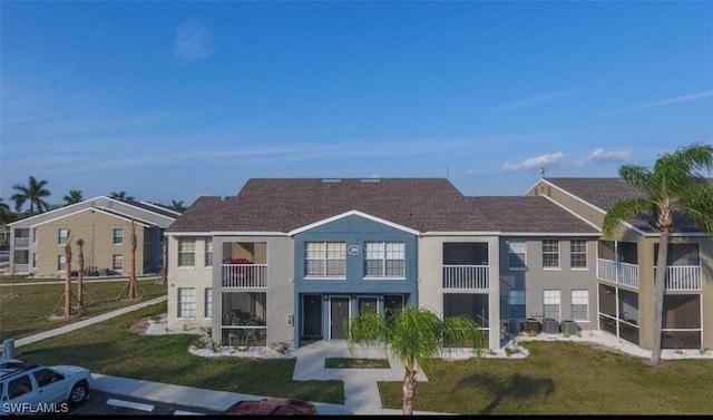 142 Santa Clara Dr Unit 7, Naples, FL 34104 - exterior space with a yard, a balcony, roof with shingles, and stucco siding
