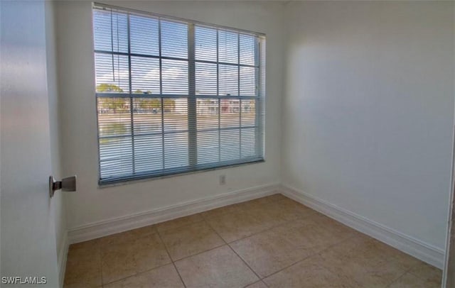 142 Santa Clara Dr Unit 7, Naples, FL 34104 - unfurnished room with light tile patterned floors and baseboards