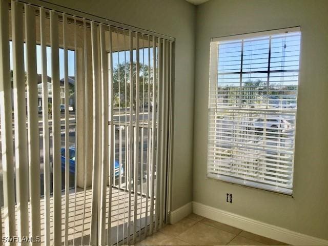 142 Santa Clara Dr Unit 7, Naples, FL 34104 - doorway featuring baseboards and tile patterned flooring