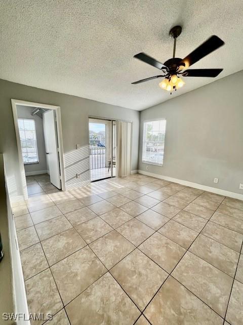 142 Santa Clara Dr Unit 7, Naples, FL 34104 - empty room featuring baseboards, a textured ceiling, ceiling fan, and light tile patterned floors