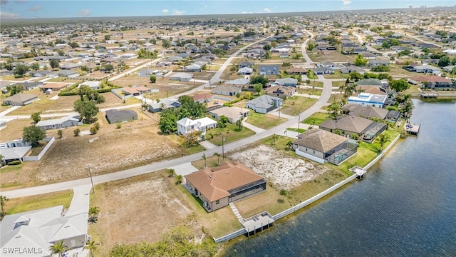 drone / aerial view with a residential view and a water view