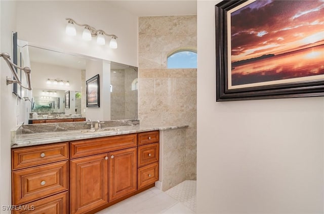 bathroom with a walk in shower and vanity