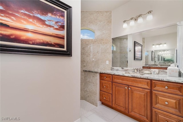 bathroom featuring walk in shower, vanity, and marble finish floor