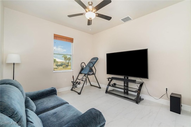 living area with baseboards, visible vents, a ceiling fan, and marble finish floor