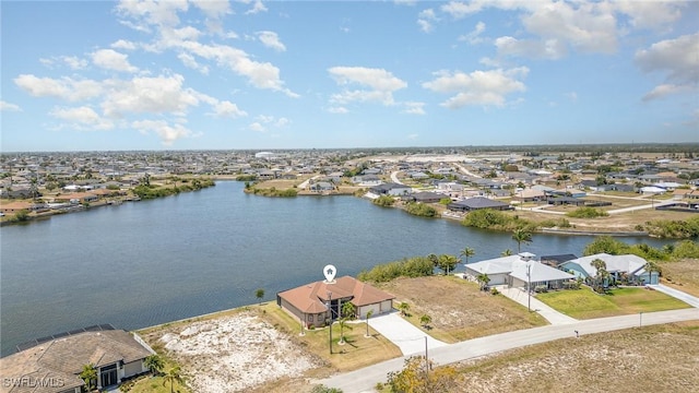 birds eye view of property with a water view and a residential view