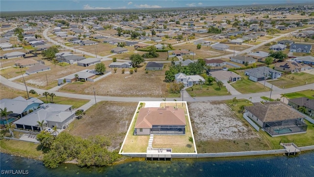 bird's eye view with a water view and a residential view