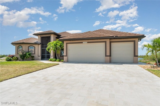 view of front of house with a tiled roof, decorative driveway, an attached garage, stucco siding, and a front lawn