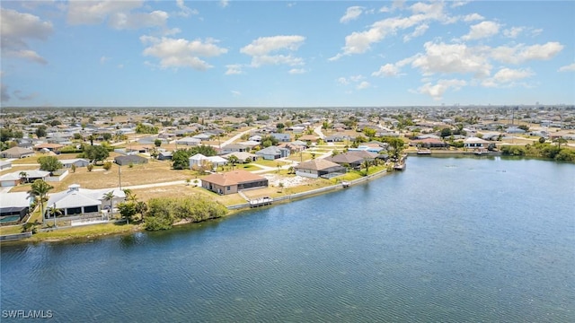 drone / aerial view with a residential view and a water view