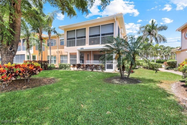 9040 Palmas Grandes Blvd Unit 101, Bonita Springs, FL 34135 - back of property featuring stucco siding and a lawn