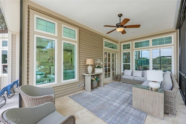 sunroom / solarium with a ceiling fan, a wealth of natural light, and french doors