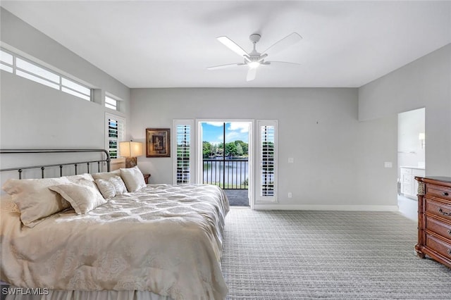 bedroom with multiple windows, access to outside, carpet, and baseboards