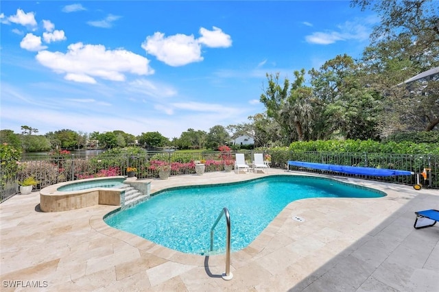 view of pool featuring fence, a pool with connected hot tub, and a patio area