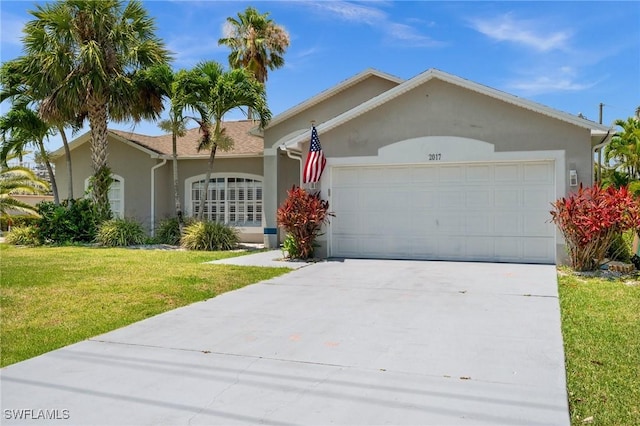 2017 Cape Coral Pkwy W, Cape Coral, FL 33914 - single story home featuring a garage, a front lawn, driveway, and stucco siding