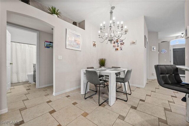 2017 Cape Coral Pkwy W, Cape Coral, FL 33914 - dining room with a chandelier, baseboards, and arched walkways