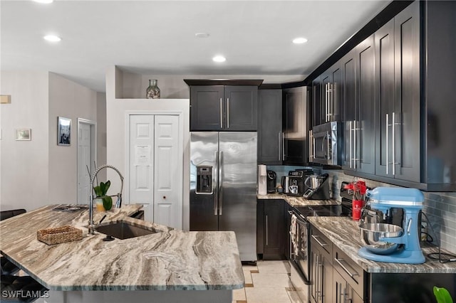 2017 Cape Coral Pkwy W, Cape Coral, FL 33914 - kitchen featuring appliances with stainless steel finishes, a sink, light stone countertops, backsplash, and recessed lighting