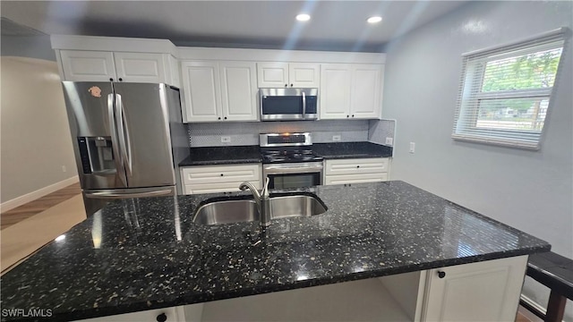 2357 Crawford St, Fort Myers, FL 33901 - kitchen with tasteful backsplash, stainless steel appliances, white cabinets, and a sink