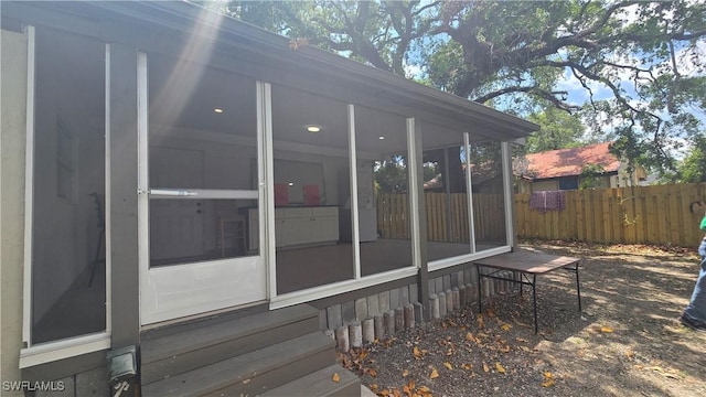 2357 Crawford St, Fort Myers, FL 33901 - view of side of home featuring fence and a sunroom