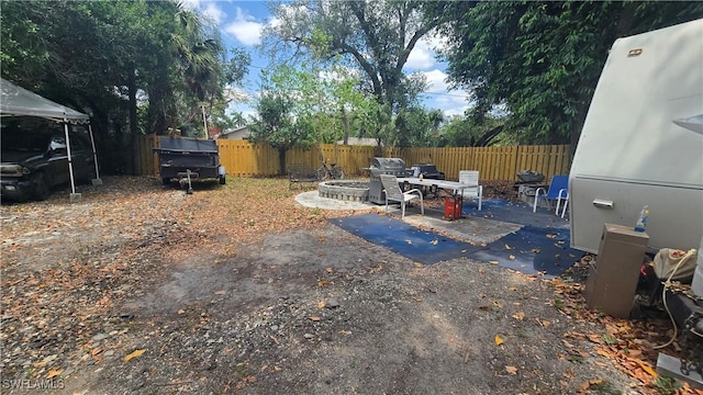 2357 Crawford St, Fort Myers, FL 33901 - view of yard featuring a fire pit, a patio area, and a fenced backyard