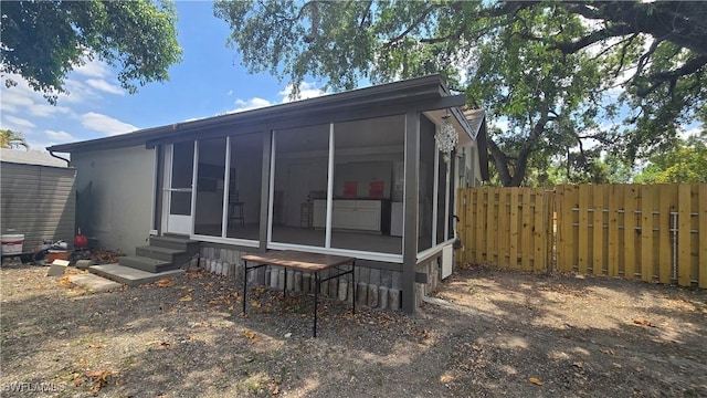 2357 Crawford St, Fort Myers, FL 33901 - rear view of property with fence, entry steps, and a sunroom