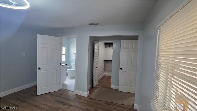 2357 Crawford St, Fort Myers, FL 33901 - unfurnished bedroom featuring a closet, baseboards, wood finished floors, and ensuite bath