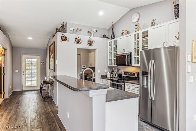 705 Columbus Blvd S, Lehigh Acres, FL 33974 - kitchen with stainless steel appliances, dark countertops, baseboards, white cabinets, and dark wood-style flooring