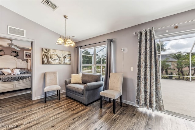 705 Columbus Blvd S, Lehigh Acres, FL 33974 - living area with vaulted ceiling, wood finished floors, a chandelier, baseboards, and a ceiling fan