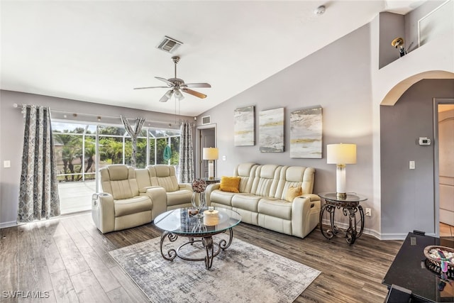 705 Columbus Blvd S, Lehigh Acres, FL 33974 - living area featuring arched walkways, a ceiling fan, vaulted ceiling, wood finished floors, and baseboards
