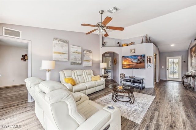 705 Columbus Blvd S, Lehigh Acres, FL 33974 - living room with arched walkways, ceiling fan, wood finished floors, baseboards, and vaulted ceiling